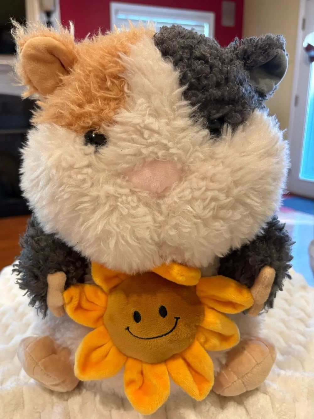 24” Russ sunflower cuddle Guinea Pig Plush holding a small yellow sunflower
